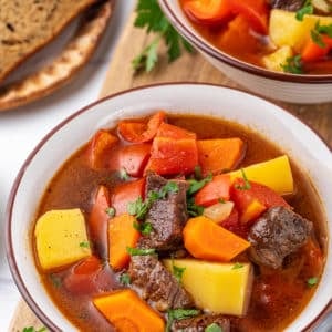 Healthy hearty soup in a white bowl.