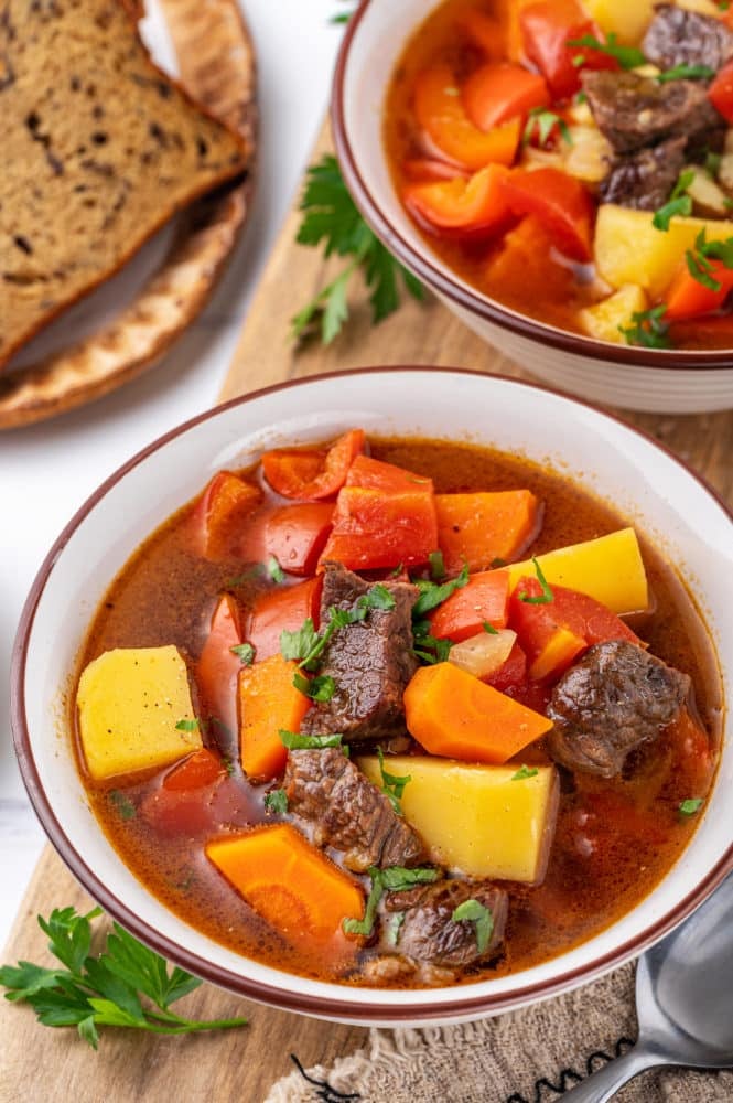 Healthy hearty soup in a white bowl.