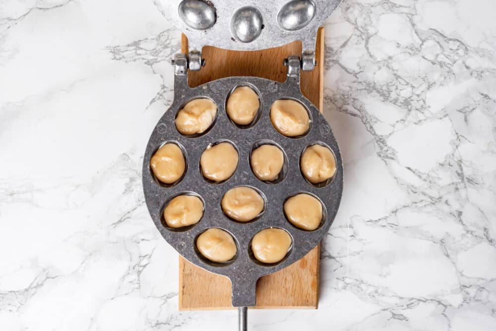 Cooking walnut cookie in a walnut cookie pan.