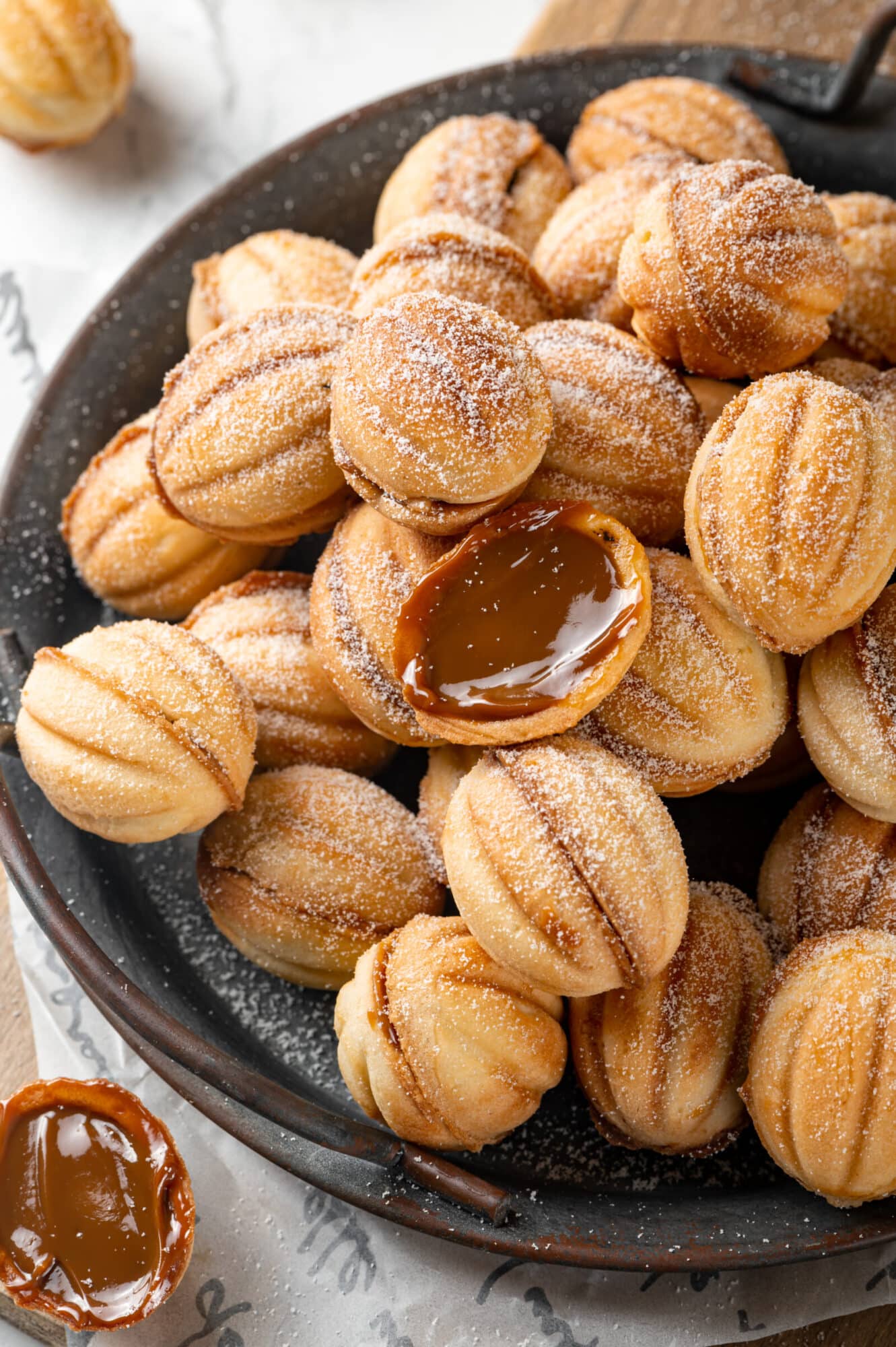 Open walnut cookies ready to eat filled with dulce de leche.