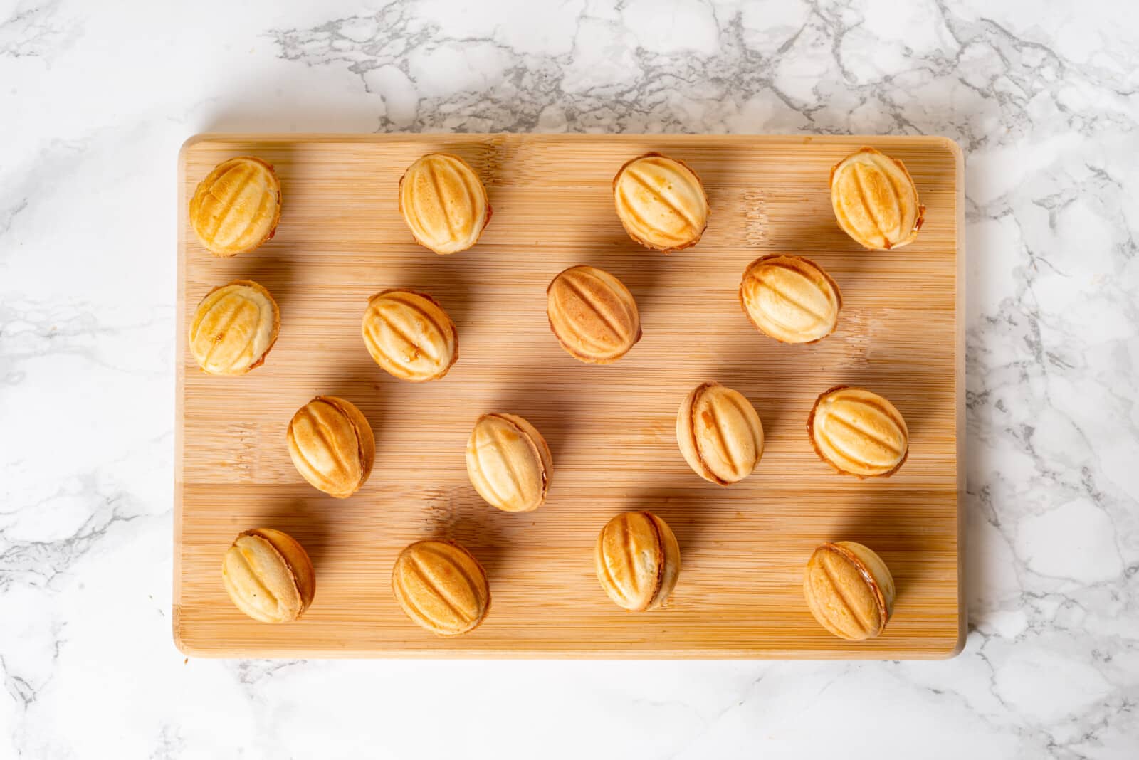 Walnut cookies on a wooden board.