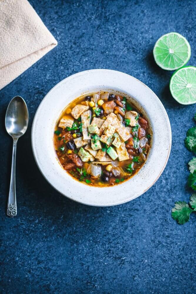 chicken-soup-in-a-white-bowl-with-a-spoon-and-lime-on-the-side