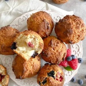 muffins-on-a-white-plate-with-a-towel-and-berries