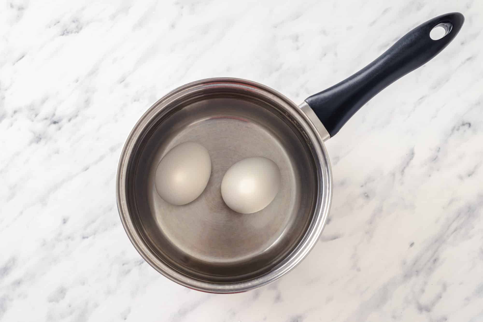 eggs boiling in a pot with water.