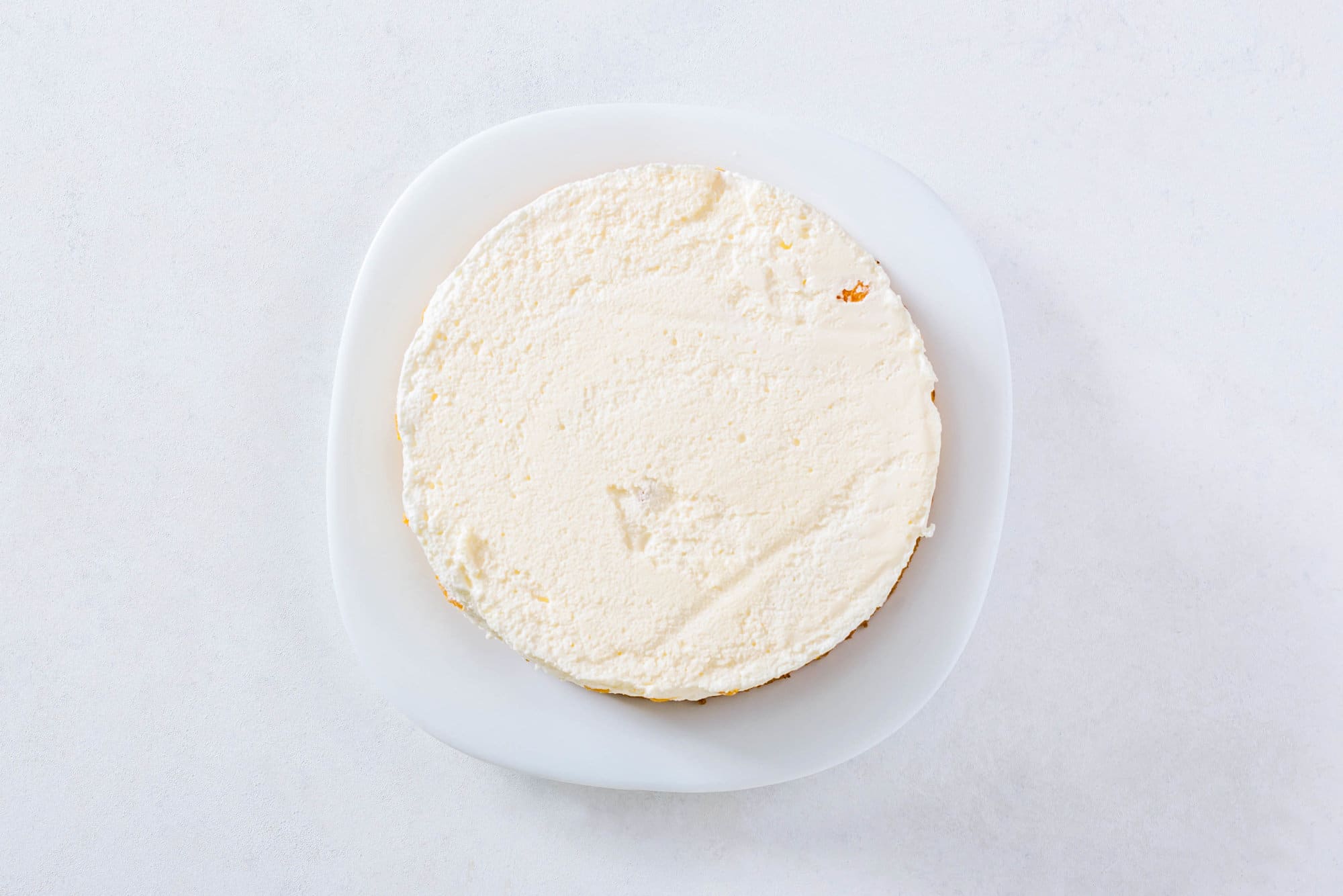 mandarin-orange-mousse-cake-layers-cream-on-a-white-plate