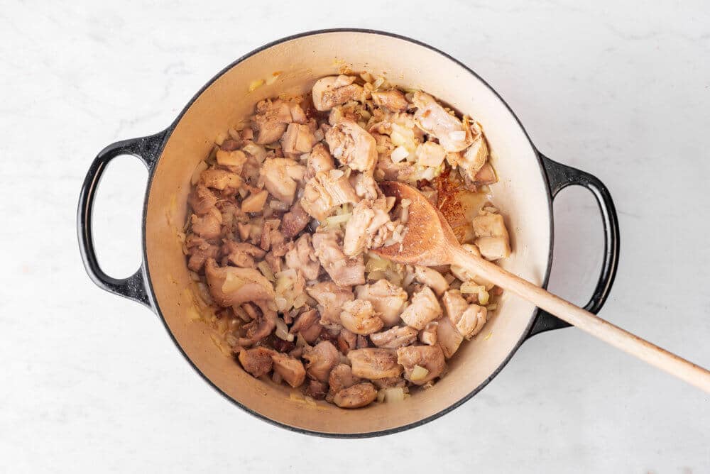 chicken-and-onion-in-a-pot-with-a-wooden-spoon