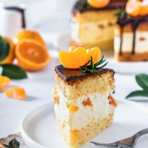 mandarin-mousse-cake-slice-on-a-white-plate-with-a-fork