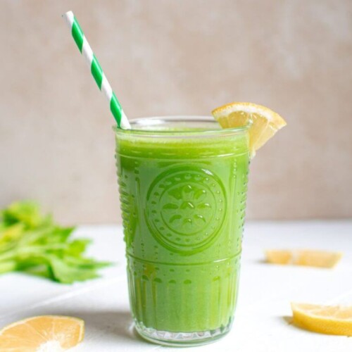 celery-juice-in-a-glass-with-a-lemon-wedge-on-the-rim-and-a-striped-straw