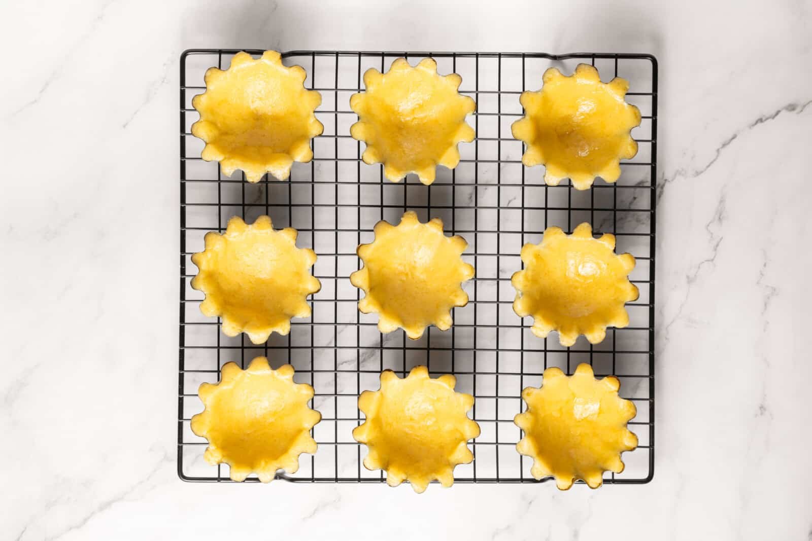 Meringue Jam Filled Tartlets Dough in tart forms.