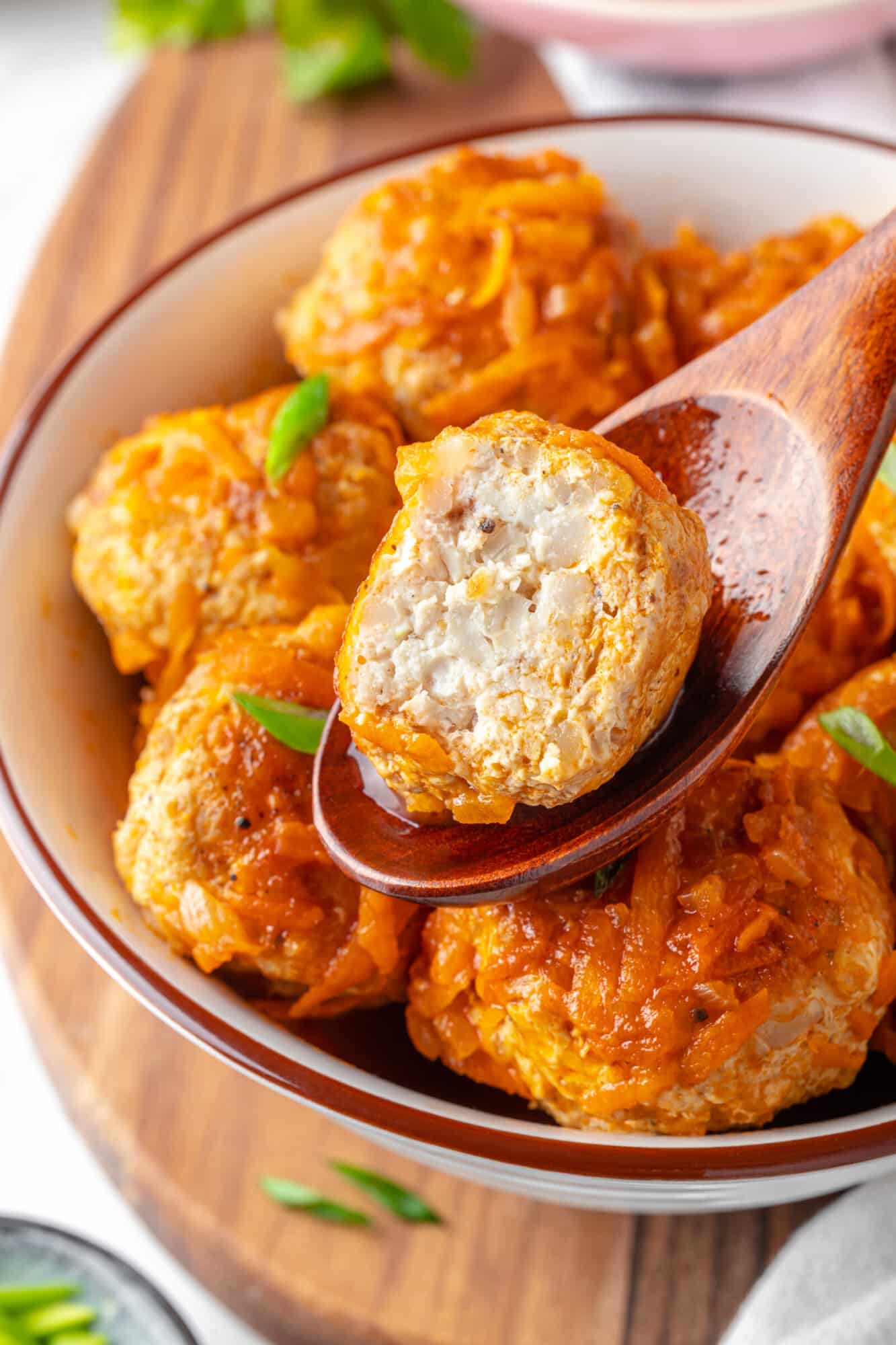 Enjoying a meatball with a wooden spoon for serving.