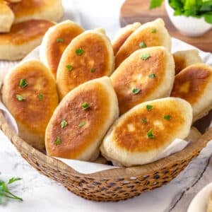 Piroshki in a bowl for serving with garnish.