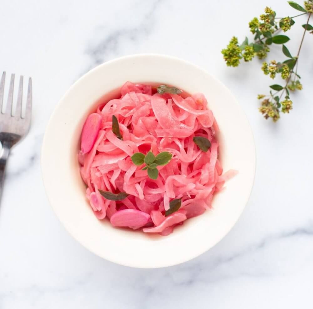 pickled-red-onions-in-a-white-bowl-with-a-fork-on-the-side