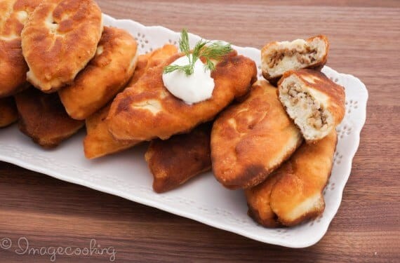 piroshki-cooked-with-meat-filling-on-a-white-plate