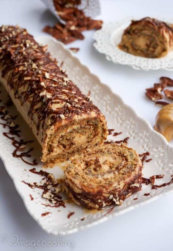 honey-pecan-roll-on-a-white-plate-with-a-honey-mixer-on-the-side