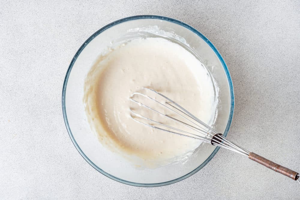 crepe-batter-process-in-a-clear-bowl-with-a-whisk