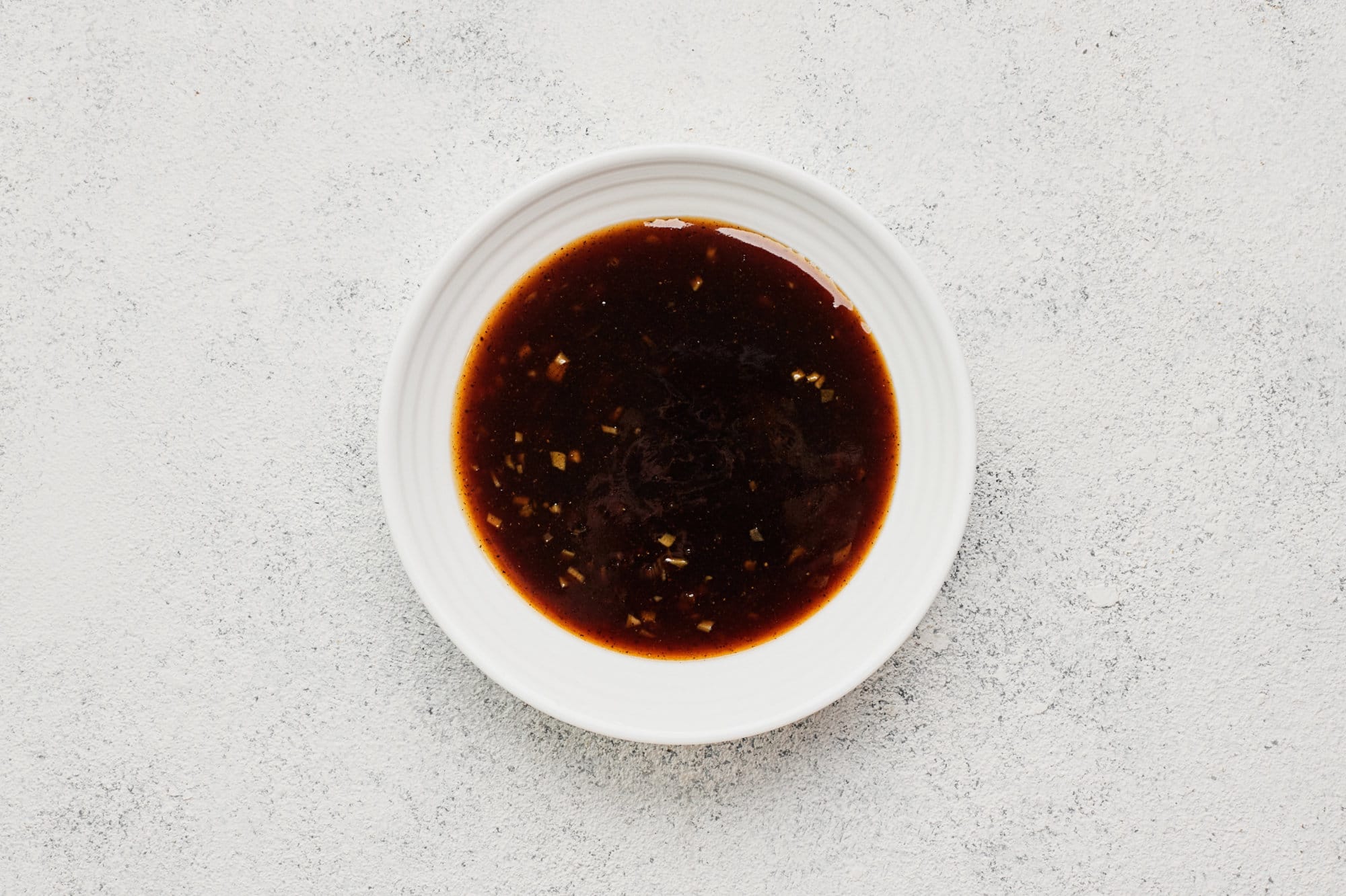 Teriyaki sauce in a white bowl.