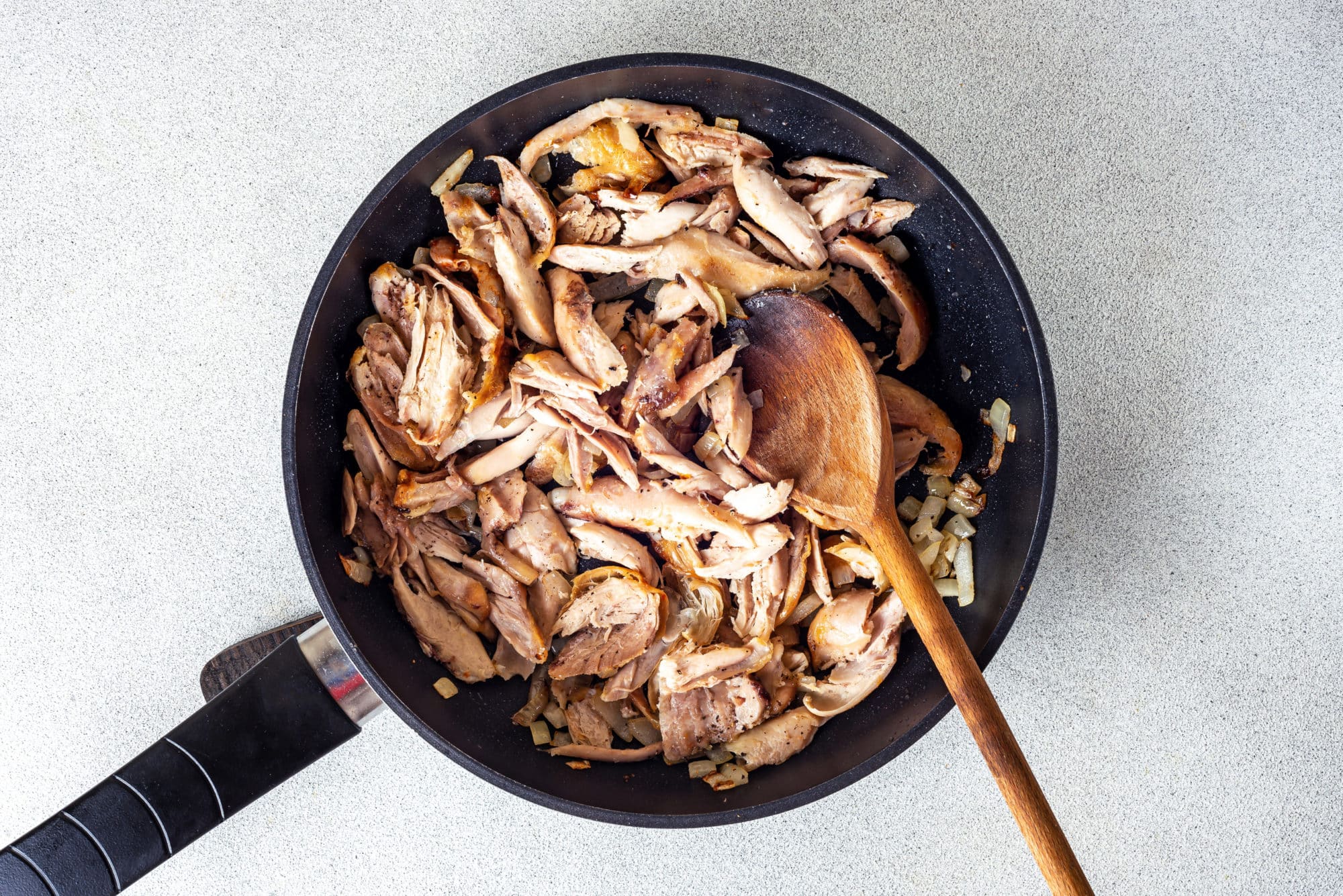 chicken-in-a-skillet-with-a-wooden-spoon