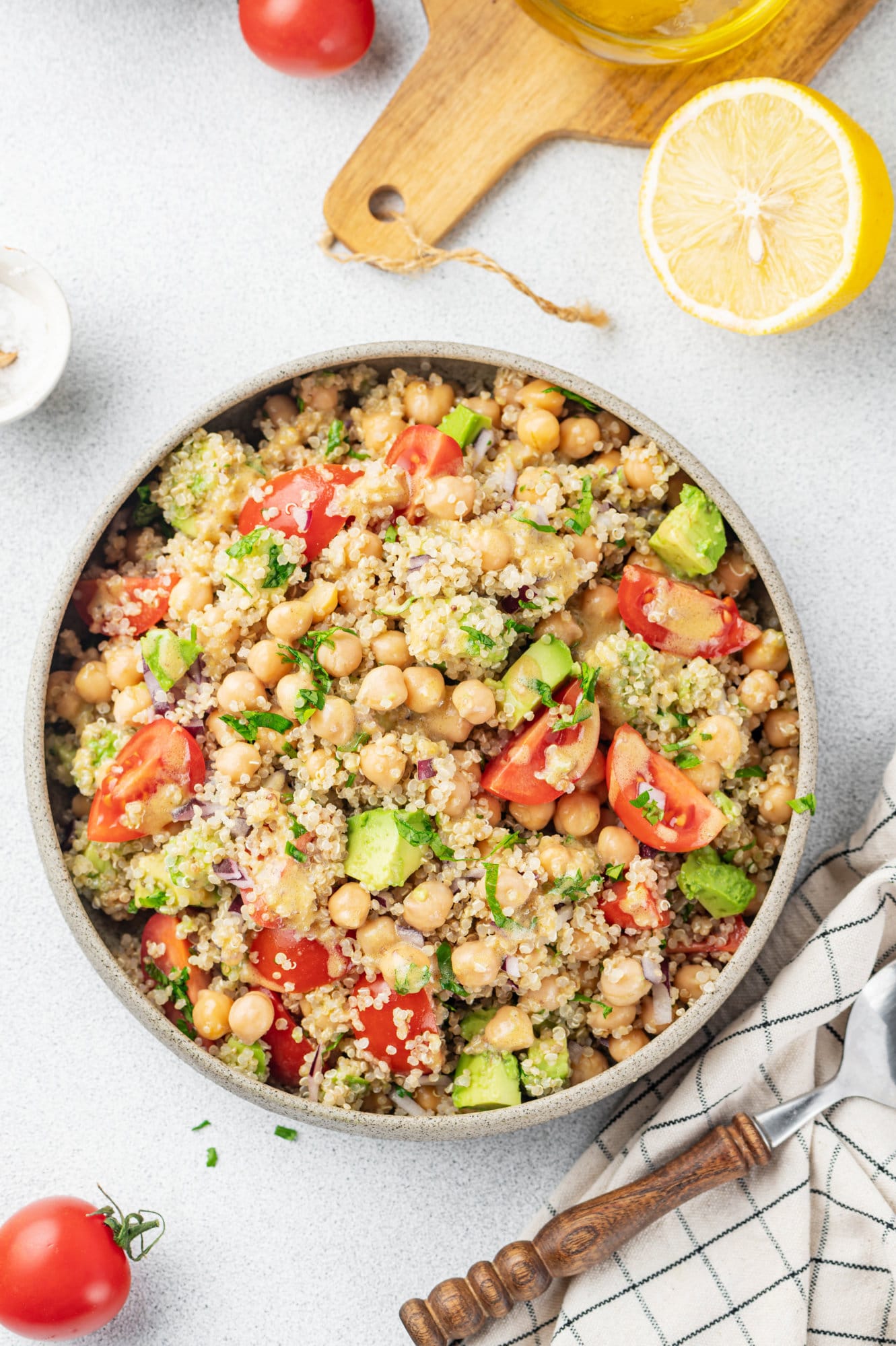 quinoa-chickpea-salad-in-grey-bowl-spoon-with-towel