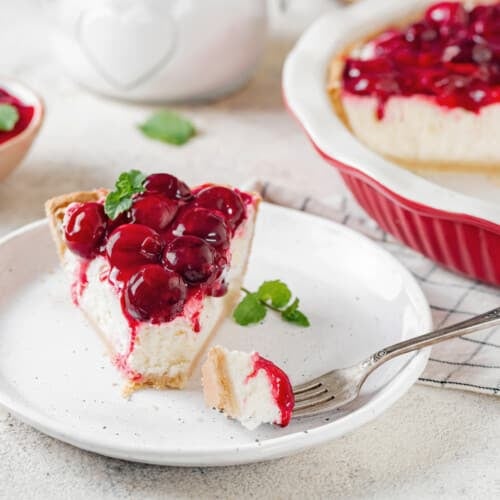 cheesecake-slice-on-a-white-plate-with-a-fork