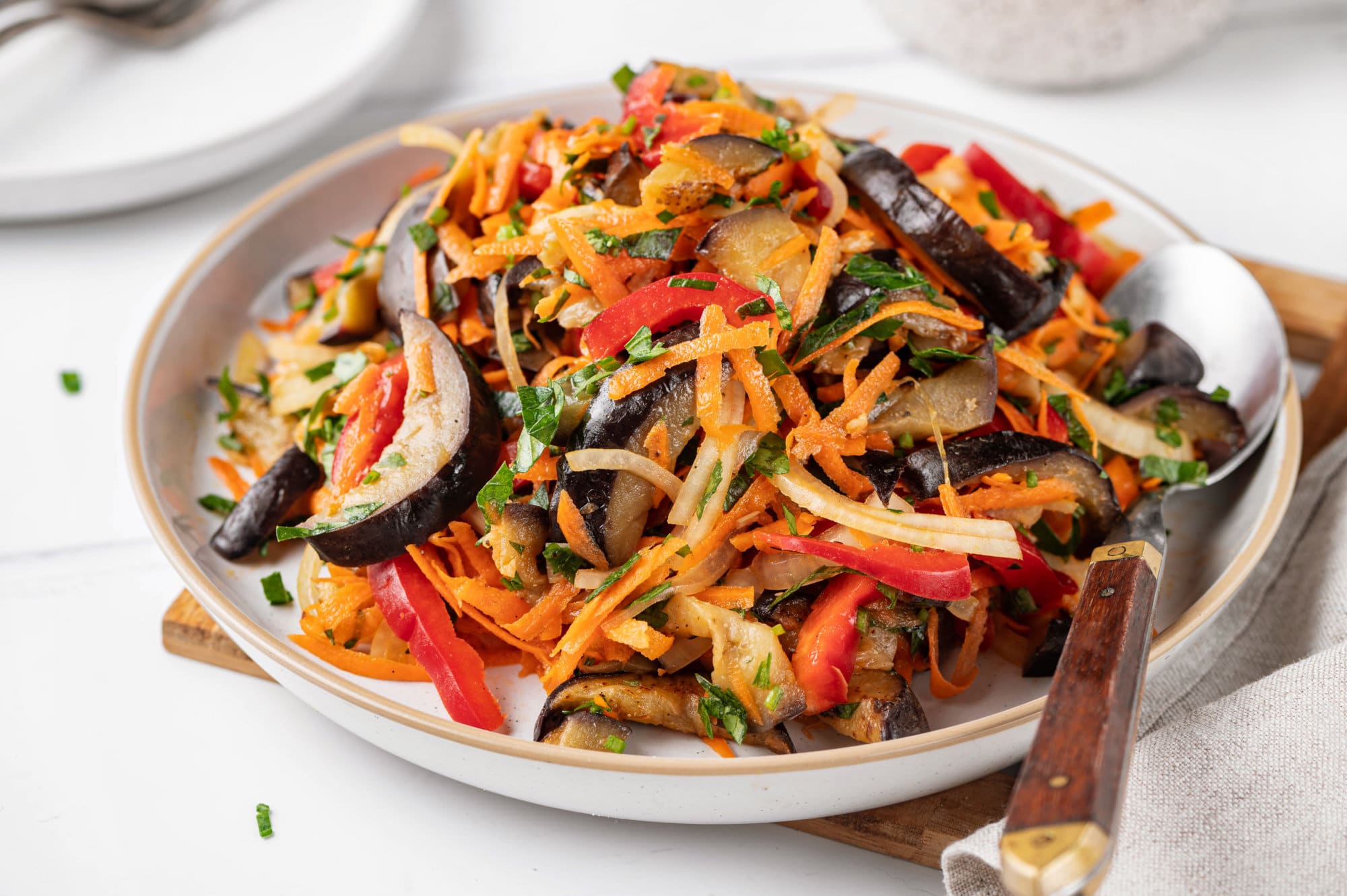 eggplant-salad-on-white-plate-with-spoon