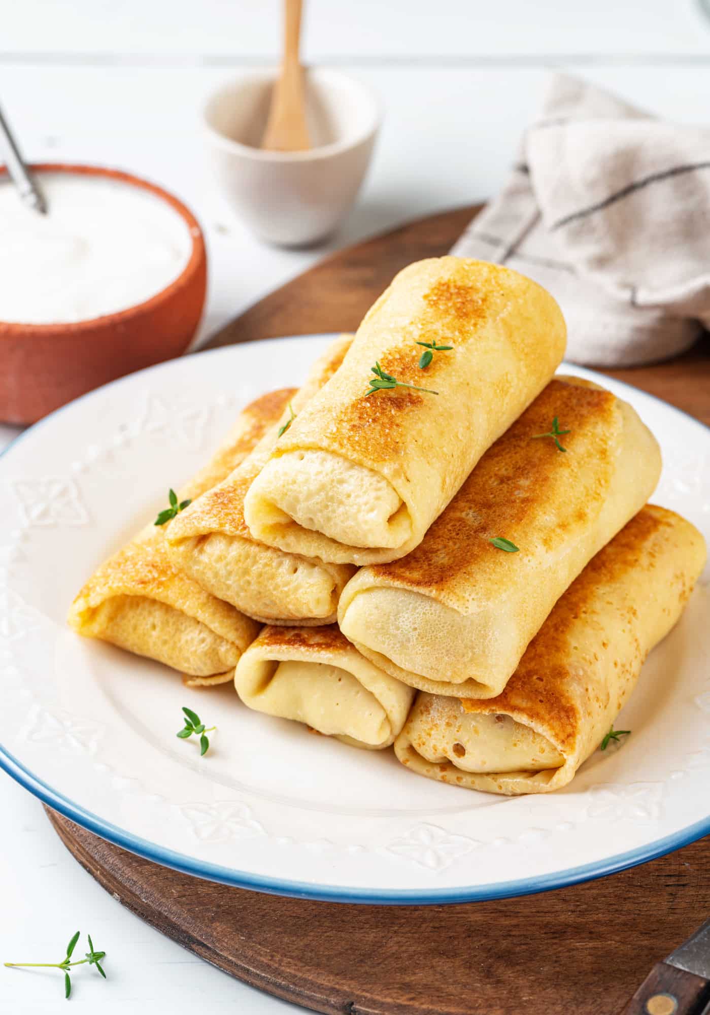 folded-crepes-stacked-on-a-white-plate