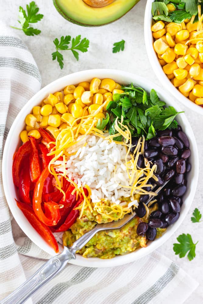 veggie-rice-bowl-on-towel-with-fork-and-parsley