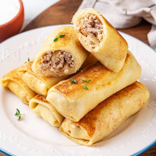 crepes-with-chicken-filling-stacked-on-a-plate