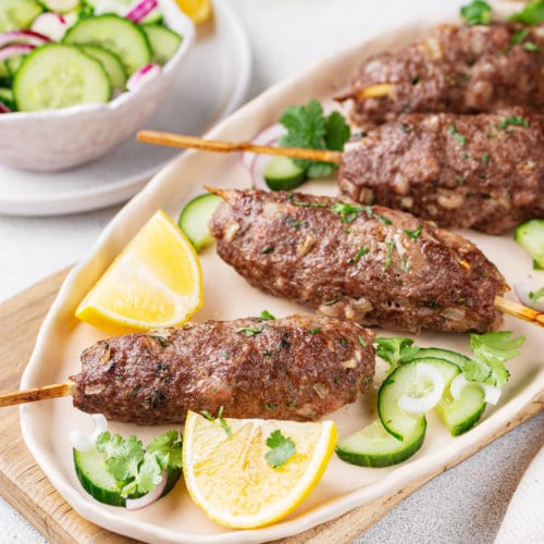 lamb-kebab-on-a-plate-with-lemon-and-cucumber