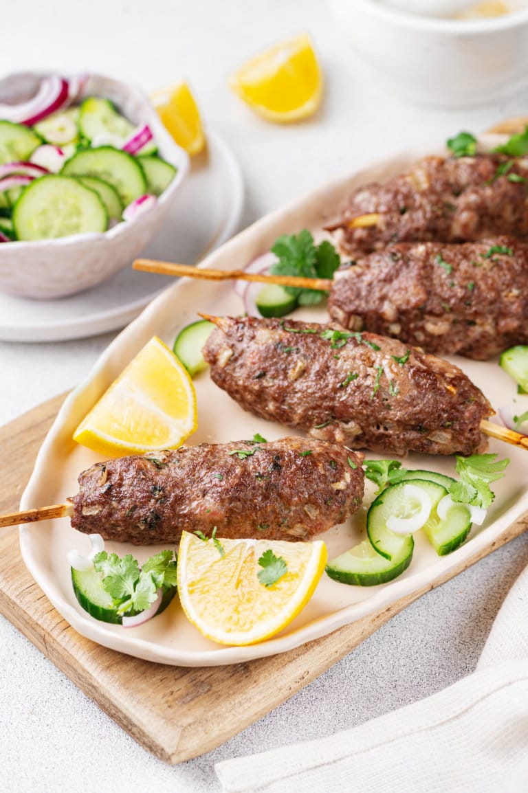 lamb-kebab-on-a-plate-with-lemon-and-cucumber