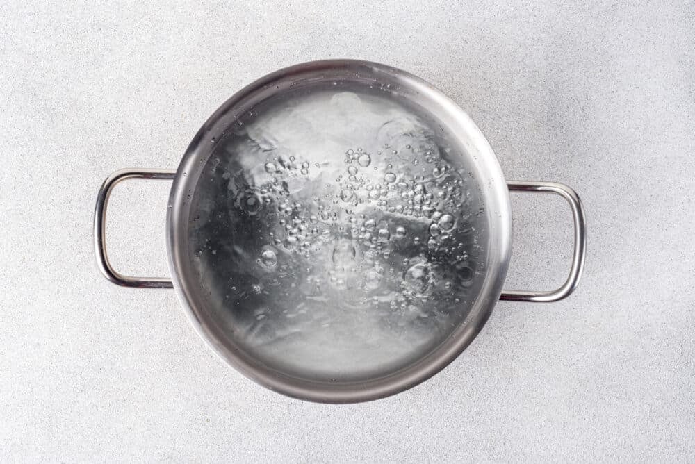 Boiling water in a silver pot.