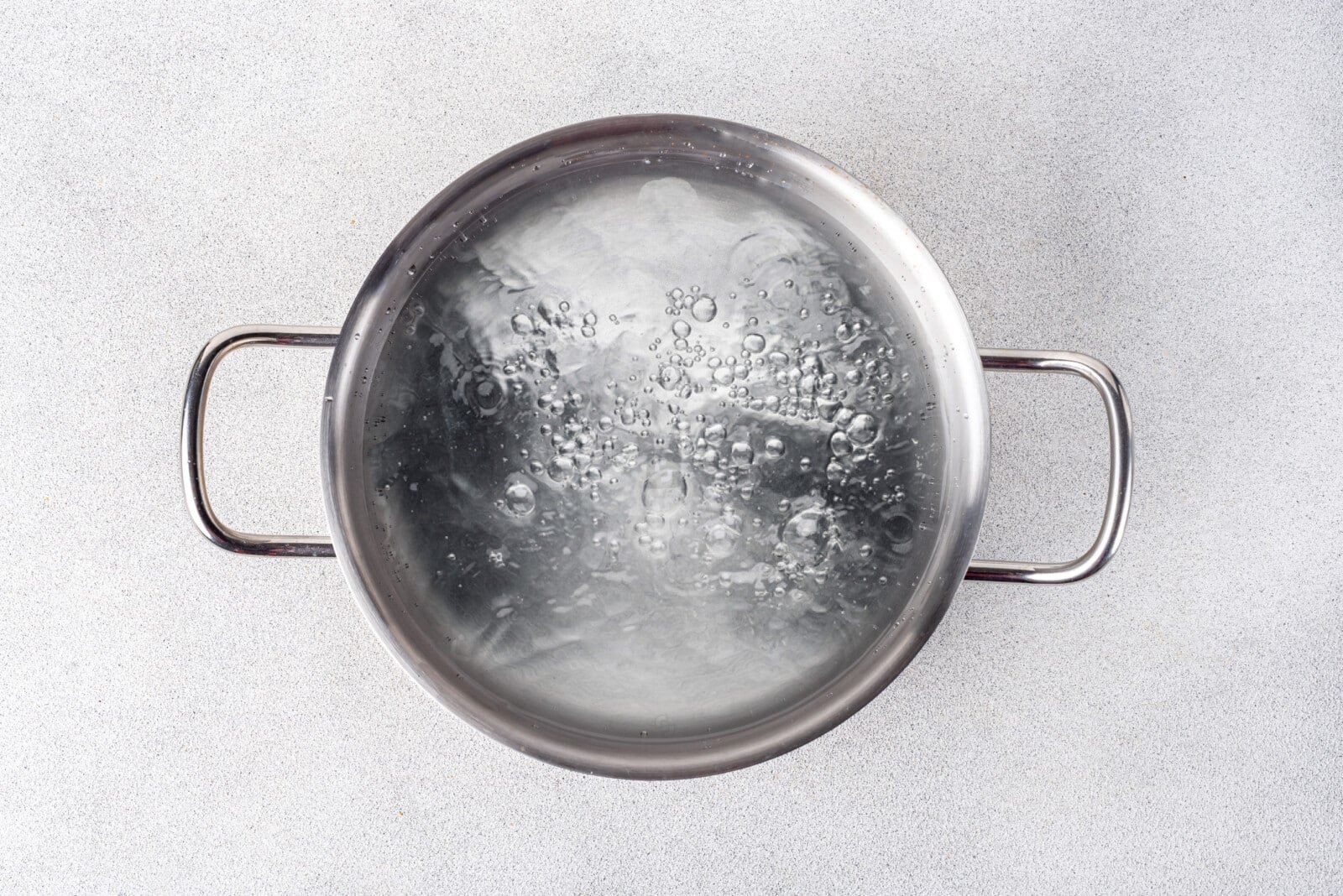 Boiling water in a silver pot.