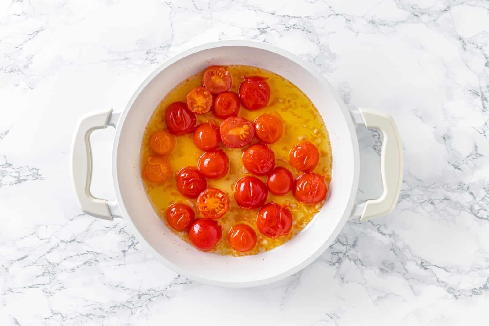 cherry tomatoes in butter and olive oil in a pan.