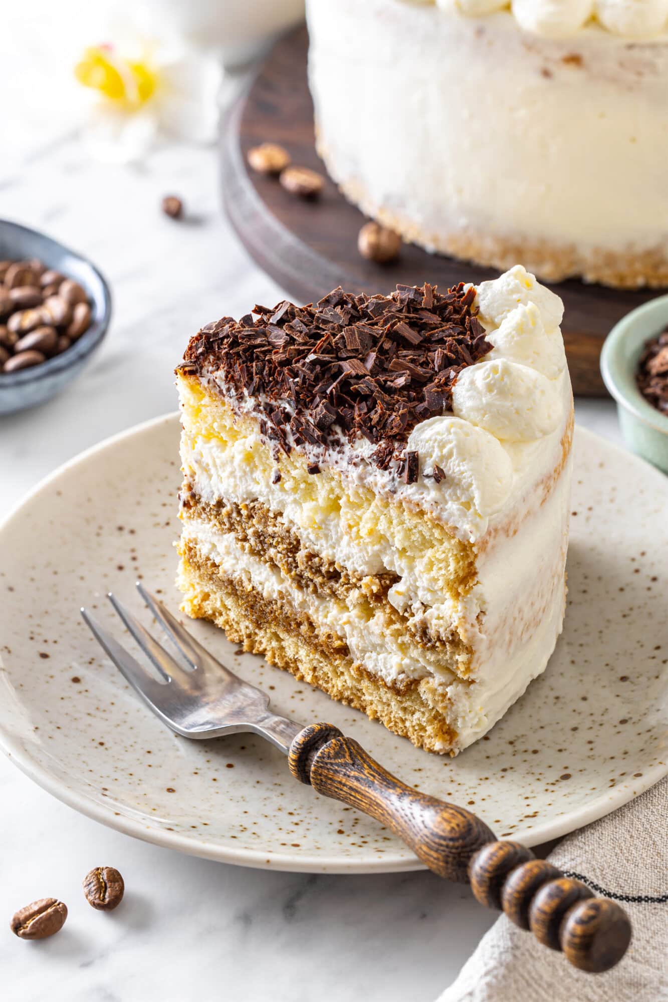 Tiramisu cake on a white plate ready to eat.