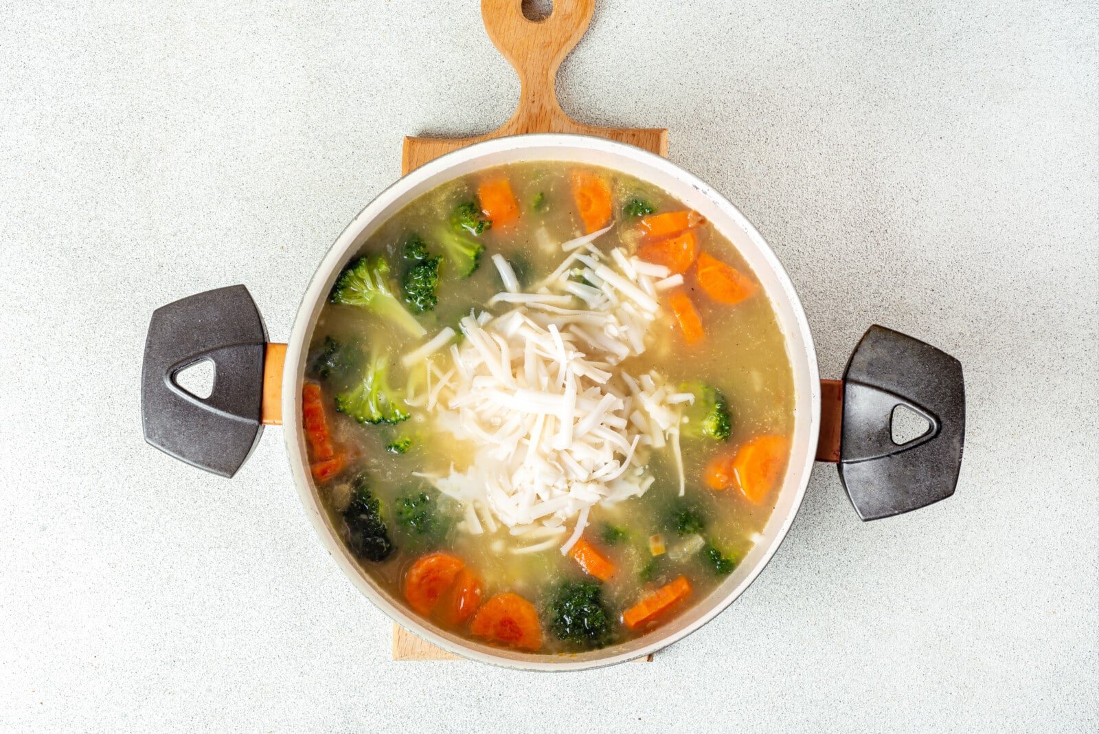 broccoli soup with veggies and broth with cheese added in.