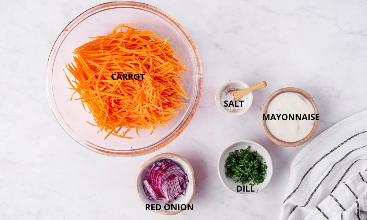 grated carrots in a bowl pinch of salt chopped red onion chopped fresh green dill and mayonnaise in a small bowl.