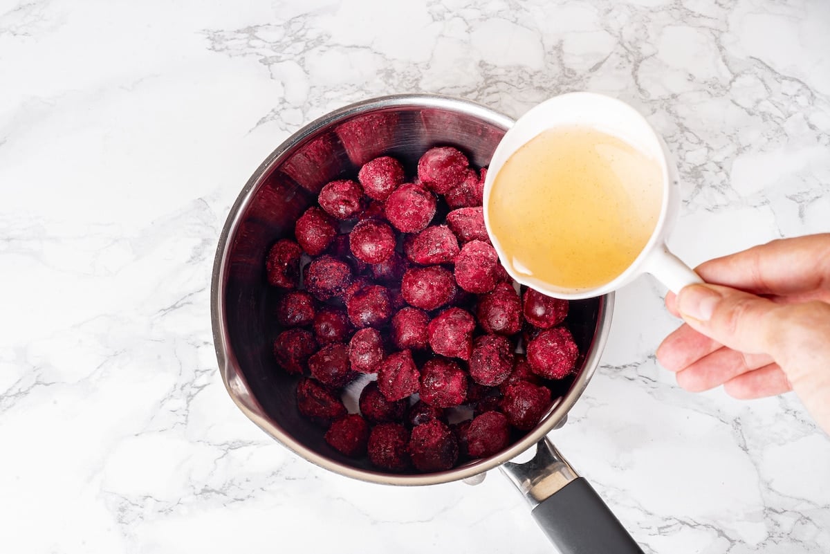 pitted cherries in a suacepam with adding agave