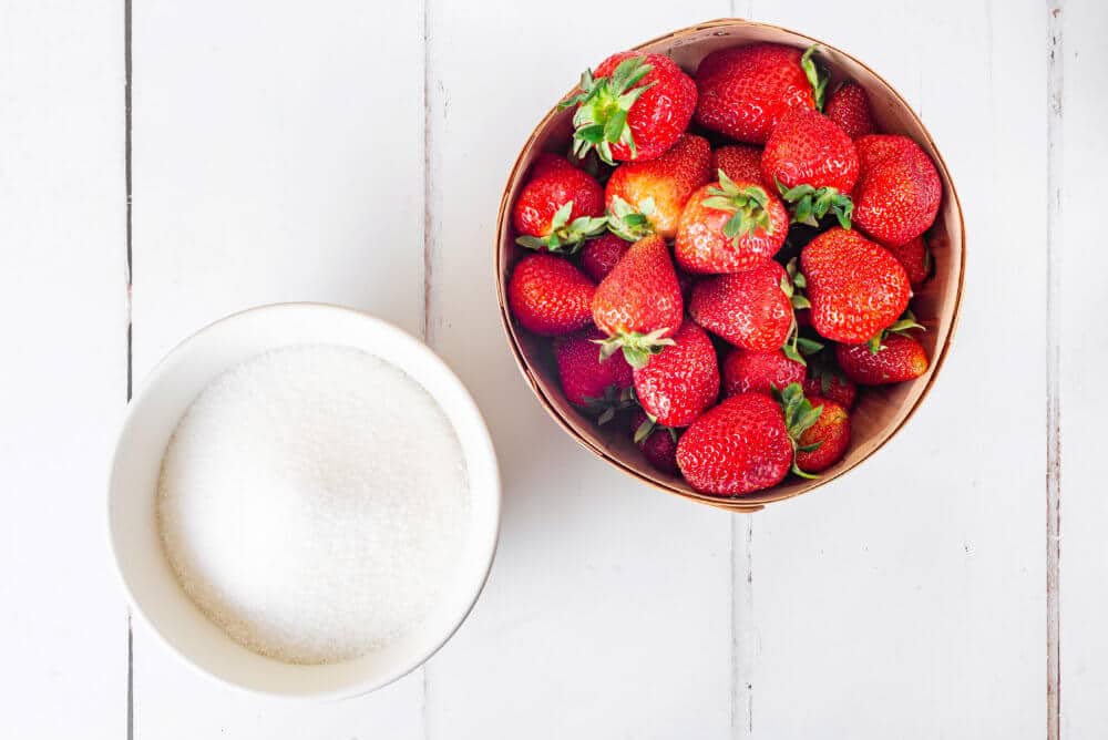 strawberry-jam-ingredients-strawberries-in-a-brown-bucket-and-sugar-in-a-white-bowl