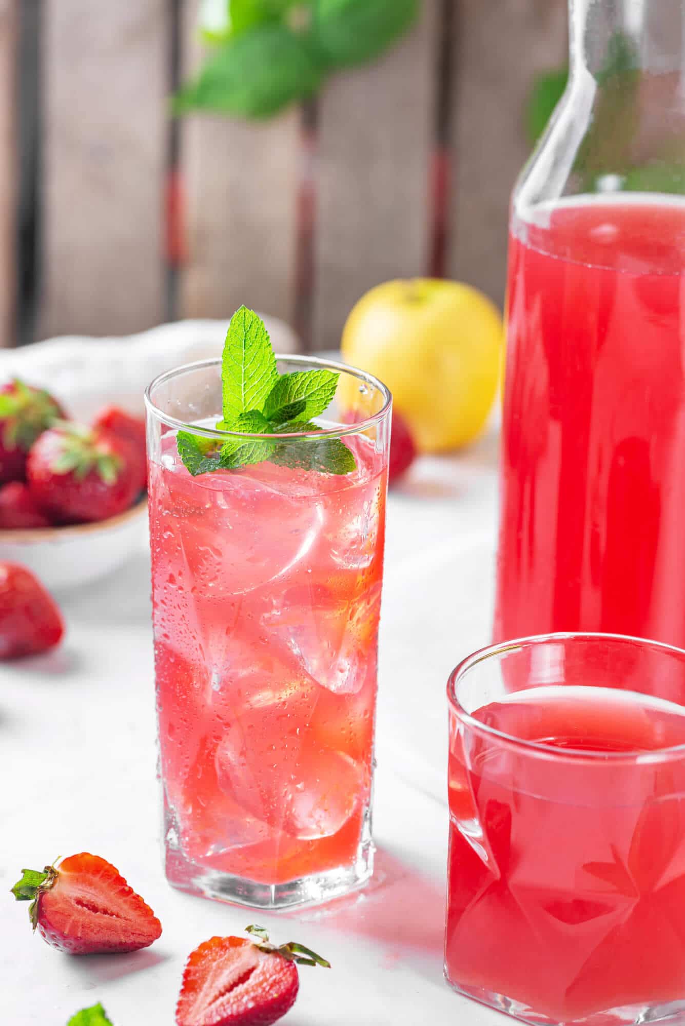 fruit-juice-in-glasses-with-fruits-scattered-around-and-a-glass-jar-with-more-juice