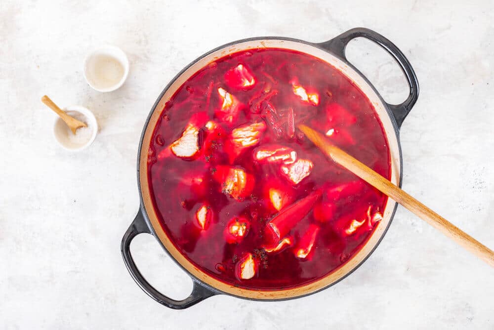 borscht-in-a-soup-pot-with-a-wooden-spoon-and-a-bowl-of-salt-on-the-side