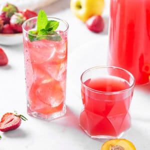 fruit-juice-in-glasses-with-fruits-scattered-around-and-a-glass-jar-with-more-juice