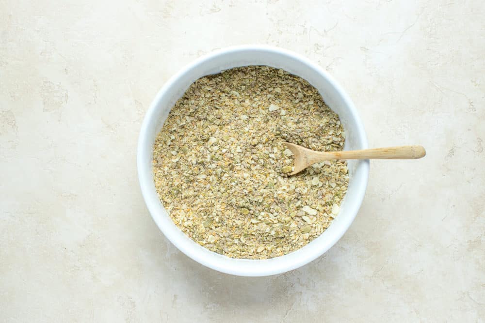 seeds-crushed-in-a-white-bowl-with-a-wooden-spoon