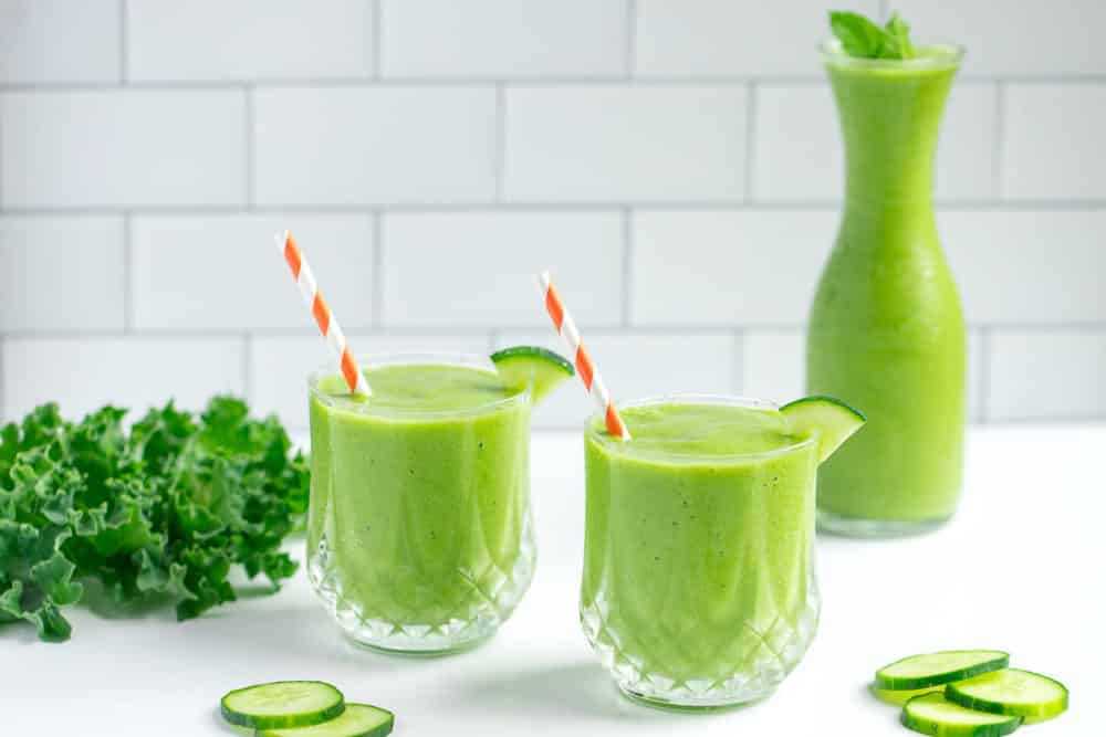green-smoothie-in-glasses-with-straws-and-cucumber-wedges