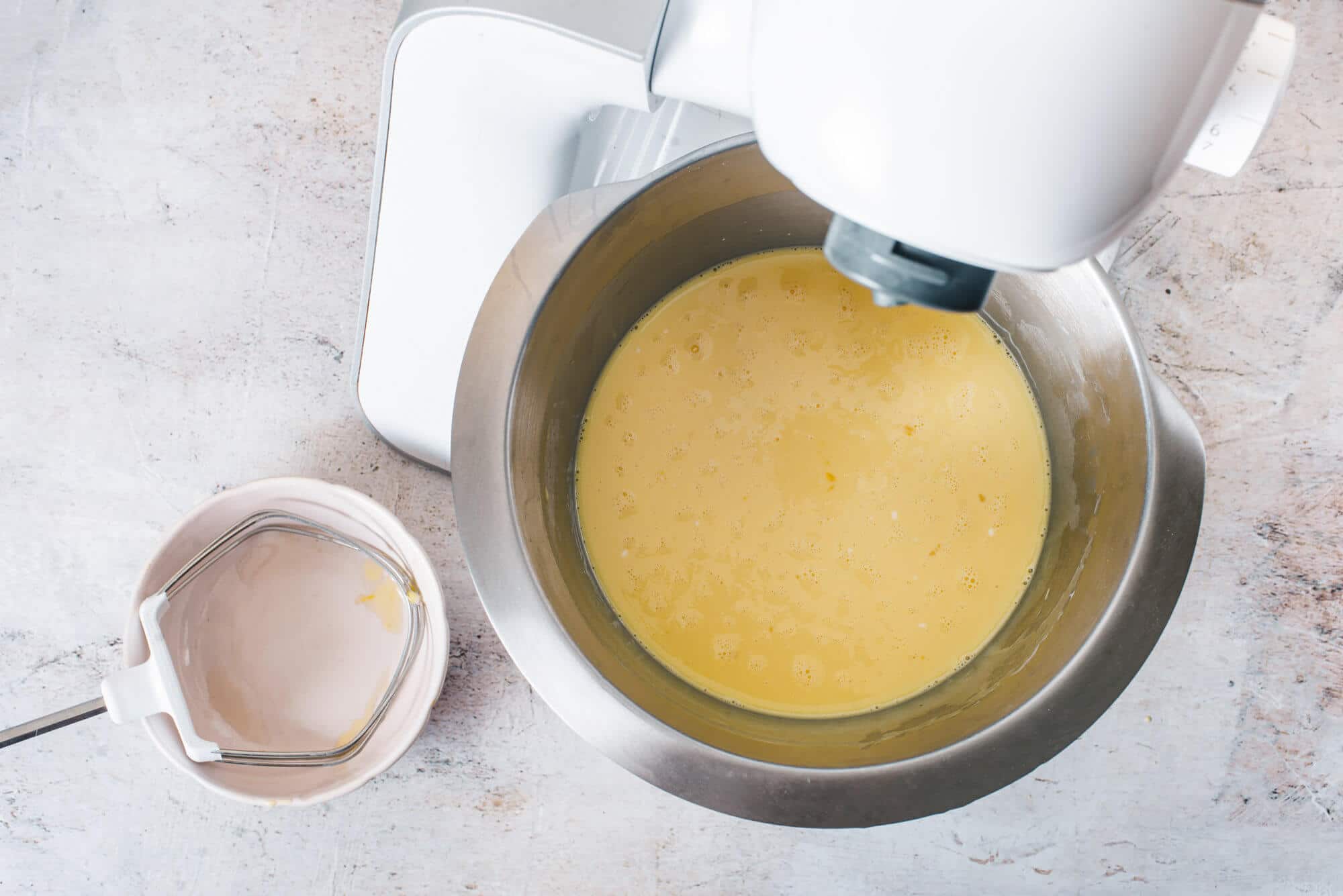 vanilla-cake-batter-in-a-stand-mixer-with-a-bowl-on-the-side
