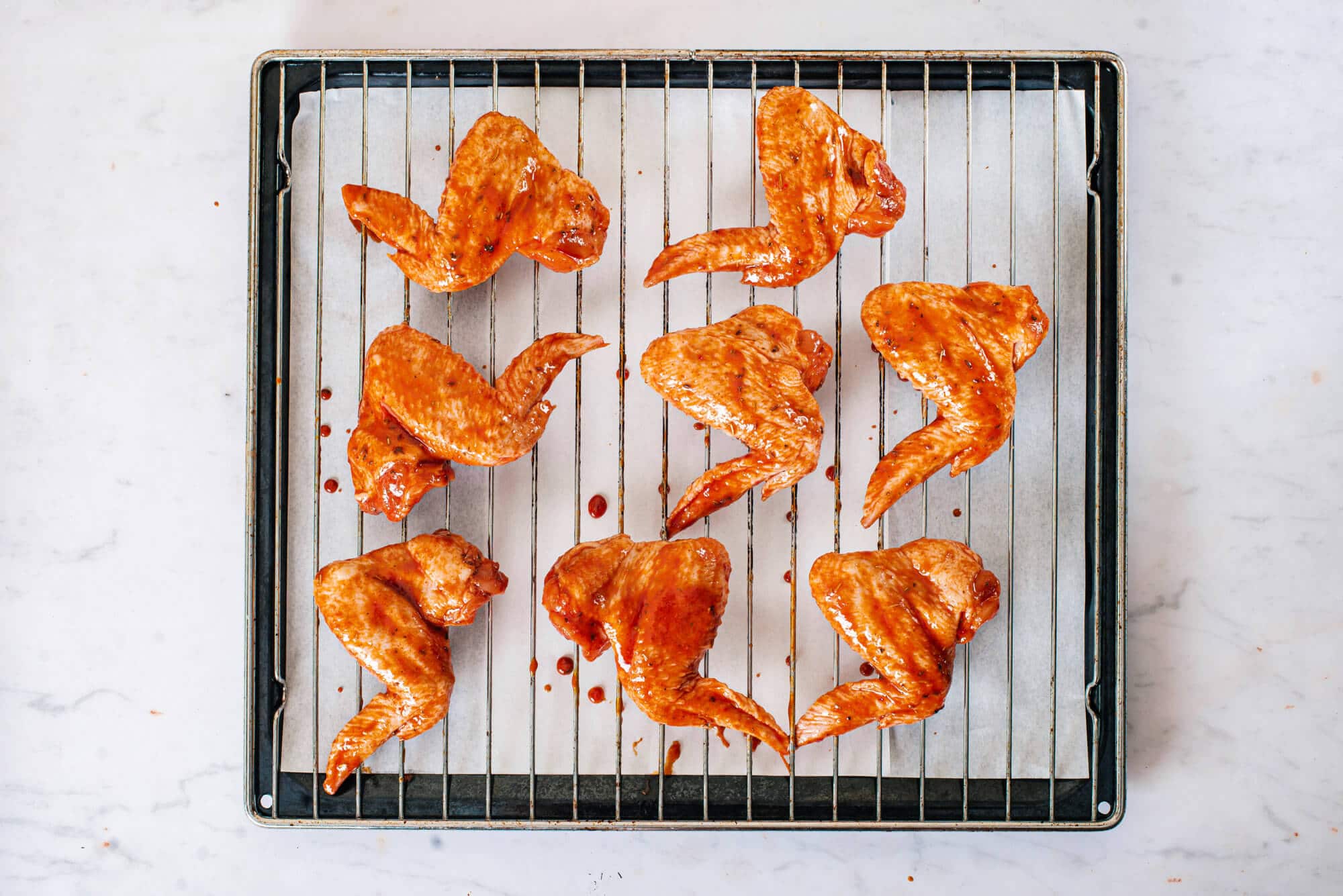 raw-chicken-wings-on-a-wire-rack-on-a-baking-tray