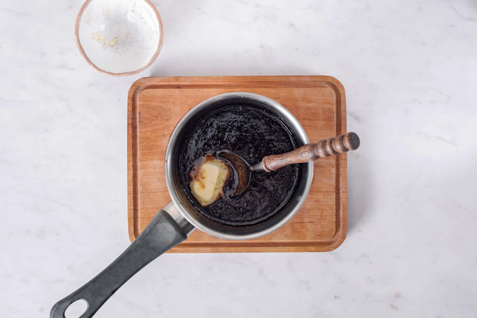 caramel ingredients for a smoothie in a saucepan on a wooden board. 