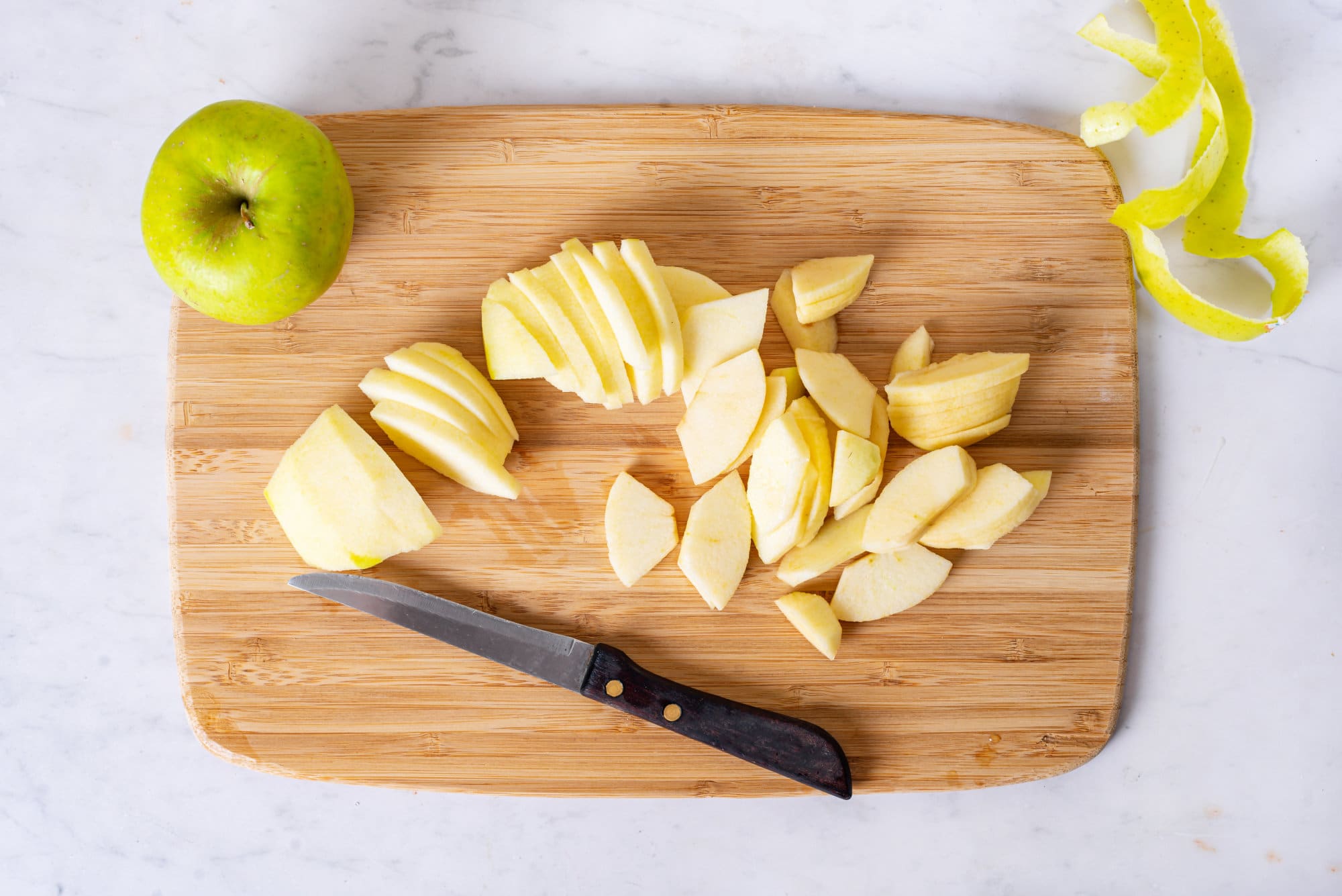 sliced and peeled apples on a cutting board. 