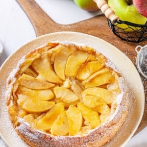 apple-cake-on-a-white-plate-on-a-wooden-board