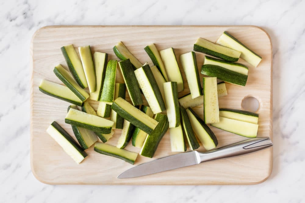 zucchini-sliced-on-a-wooden-board-with-a-knife