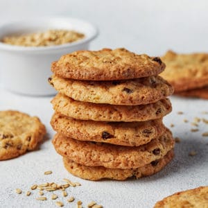 A stack of oatmeal cookies on parchment paper.