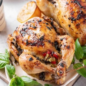 cornish-hens-on-a-white-plate-with-basil-on-a-wooden-board